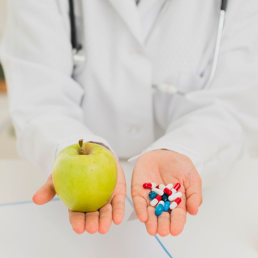 close-up-doctor-holding-green-apple-pills_23-2148302155